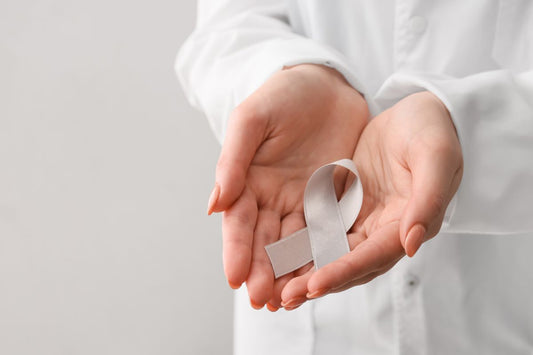 A doctor holding grey color ribbon to promote asthama awareness.