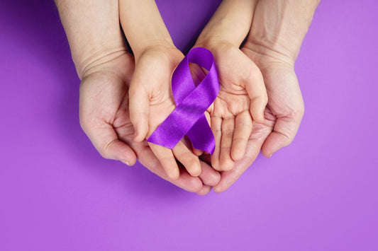 Two hands holding purple ribbon showing support for lupus disease awareness.